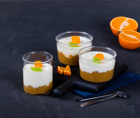 Vanilla Panna cotta in a Cup, Italian dessert creamy jelly with a tangerine layer, decorated with...