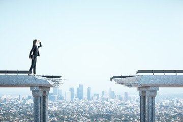 Businesswoman standing on bridge with gap