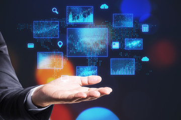 Businessman hand holding business interface hologram.