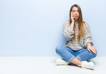 young blonde woman feeling bored, frustrated and sleepy after a tiresome, dull and tedious task,...