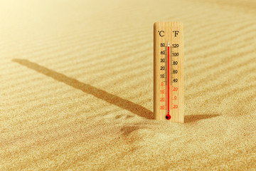 Summer heat. Thermometer in the sand shows plus 50 degrees celsius