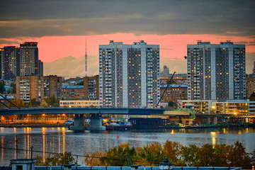 Fototapeta na wymiar Residential houses in the background of the TV tower in the evening in Moscow