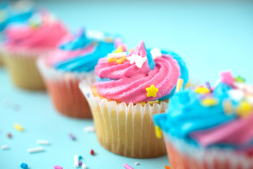 Colorful cupcakes on a  blue background