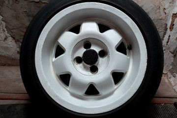 used white titanium rims and tires with excellent tread await spring