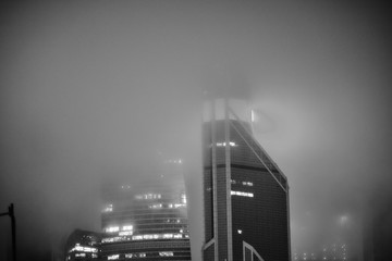 Buildings of the Moscow City office complex at night in the fog