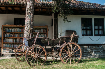 Fototapeta na wymiar Old wooden rural carriage at old village country house