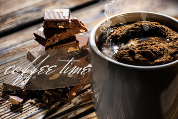 coffee cup with chocolate in the background and inscription coffee time