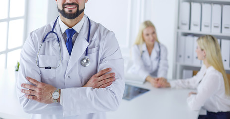 Happy doctor with medical staff at the hospital