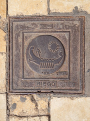 Manhole cover on pavement with patterns
