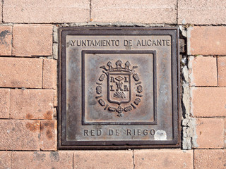 Manhole cover on pavement with patterns