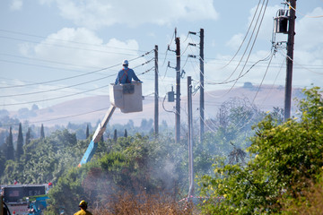 Electrical worker repairs power lines that caused a fire