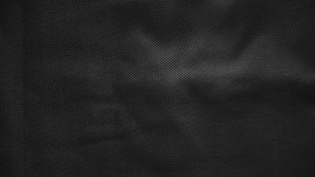 Stop motion animated black canvas pattern background. Surface with spotlight, dark tone.