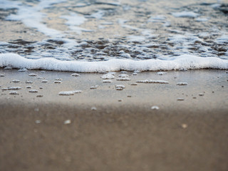 Sea wave is incident on the sand near the shore.