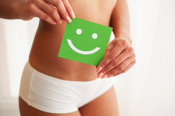 Closeup Of Healthy Female With Beautiful Fit Slim Body In White Panties Holding White Card With...