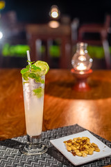 Delicious food and drink on wooden table with candle in restaurant