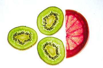 Translucent sliced kiwi and grapefruit closeup fresh juicy