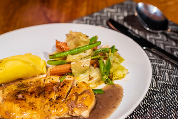Delicious food and drink on wooden table with candle in restaurant