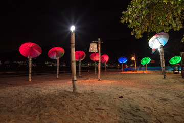 Decoration with umbrellas with colorful lights on the night beach of Abraao in Ilha Grande (big island) in the city of Angra dos Reis, south of Rio de Janeiro, Brazil, world heritage site
