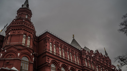 Obraz premium Beautiful historical building in center of old city. Brick structure on cloudy day.