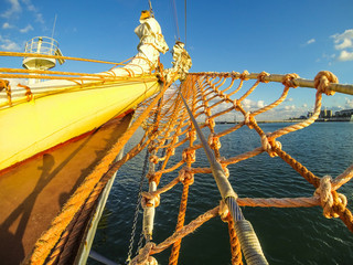 bowsprit of the sailing ship close up on a background of port