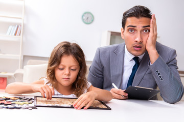Child psychologist attending small girl