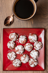 Chocolate Almond Crinkle Cookies on a Red Plate with Coffee