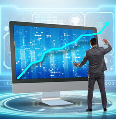 Businessman in economic forecasting concept with charts