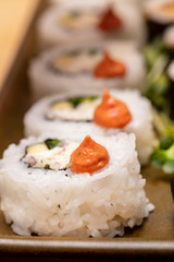 Inside and outside Sushi Rolls decorated with flowers and trimmings