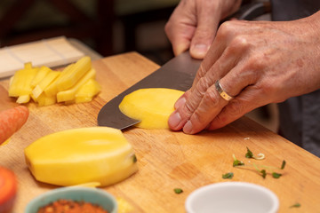 Chef demonstrating how to cut veggies for a food preparation class