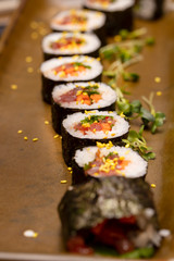 Sushi roll being sliced in a demonstaration class