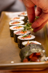 Sushi roll being sliced in a demonstaration class
