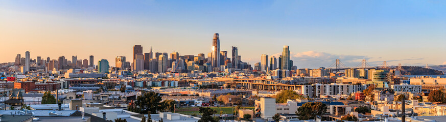 San Francisco city skyline panorama after sunset with city lights, the Bay Bridge and highway leading into the city - obrazy, fototapety, plakaty