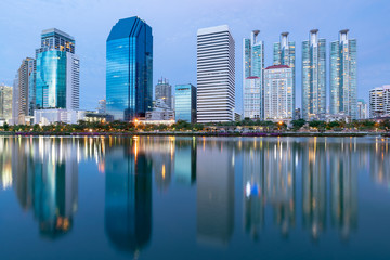 Twilight city office building reflection over water lake, cityscape background