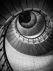 Fototapeta premium Incredible spiral staircase to the top of Eckmuhl lighthouse, on the Penmarsh Peninsula. Black and white image. Brittany. France