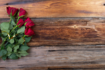 bouquet of roses on a wooden background space for text, free space