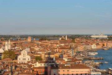 Fototapeta na wymiar Picturesque panoramic view of Venice, Italy. Aerial scenery view with red roofs of houses.
