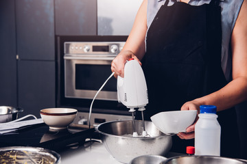 Woman beat dough mixer by machine i