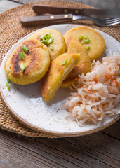 Salvadoran pupusa served with curtido  on board. view from above
