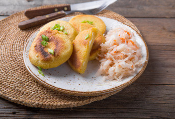 Salvadoran pupusa served with curtido  on board. view from above