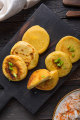 Salvadoran pupusa served with curtido  on board. view from above