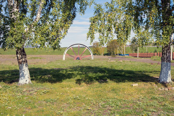A mature man inspects a huge wheel mechanism in the village of Tyrlyansk, Republic of Bashkortostan...
