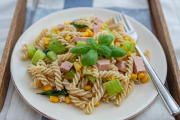 healthy italian pasta salad with corn, vegetables and ham