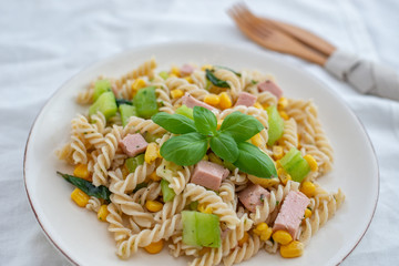 healthy italian pasta salad with corn, vegetables and ham