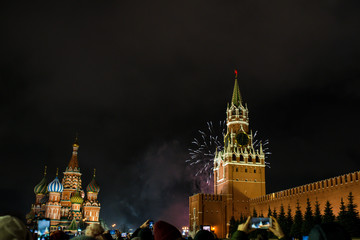 Fototapeta na wymiar salute in honor of the new year 2020 on red square against the Kremlin, Spasskaya tower and St. Basil's Cathedral