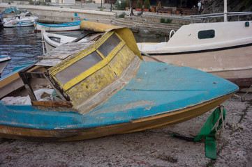 Fototapeta premium Old boat on the seashore, concept of collapse and no luck.