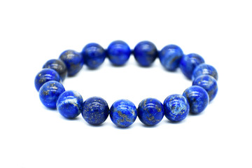 Lapis lazuli bracelet isolated on white background.  Selective focus at the front of the bracelet and leaving the back of it blurry.