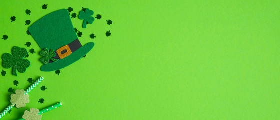 St. Patrick's day banner with Irish elf hat, cloverleafs and drinking straws decorated shamrock...