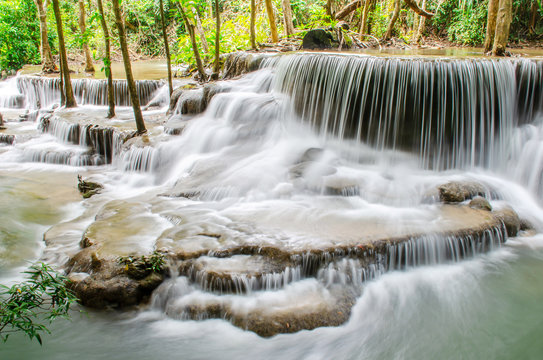 Travel to the beautiful waterfall in tropical rain forest, soft water of the stream in the natural park at Huai Mae Khamin Waterfall in Kanchanaburi, Thailand. © TeTe Song