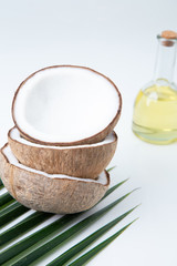  coconuts and Coconut oil  in a bottle  for cooking   nutrition  vegan ingredient  natural put on a white table,  Concept: alternative aromatherapy aromatic ingredient vitamin for therapy and massage 