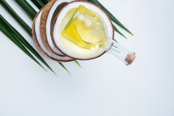  coconuts and Coconut oil  in a bottle  for cooking   nutrition  vegan ingredient  natural put on a white table,  Concept: alternative aromatherapy aromatic ingredient vitamin for therapy and massage 